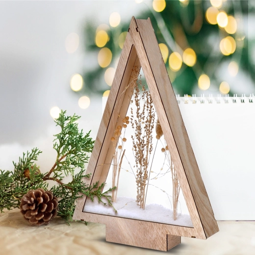 Snow-covered winter flowers in a wooden tree