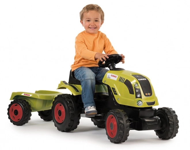 Pedalni traktor CLAAS Arion 400 z zelenim prikolidcem